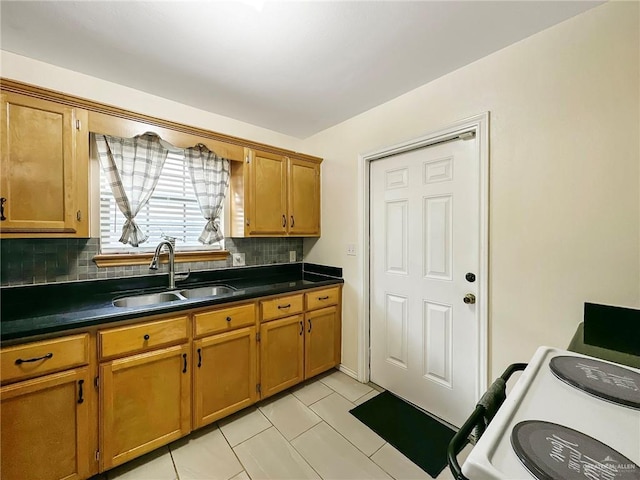 5024 Heron Ave, Mcallen, TX 78504 - kitchen with backsplash, dark countertops, brown cabinetry, and light tile patterned flooring