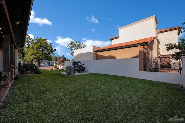 view of yard featuring cooling unit, a patio area, and fence