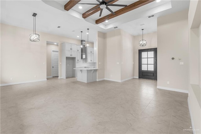 unfurnished living room with ceiling fan with notable chandelier and beam ceiling