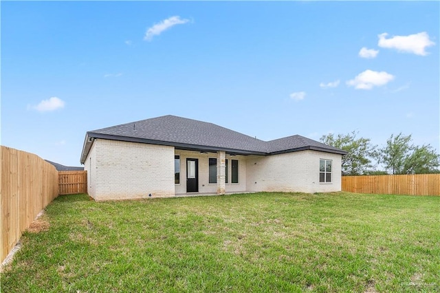 back of property featuring a yard and ceiling fan