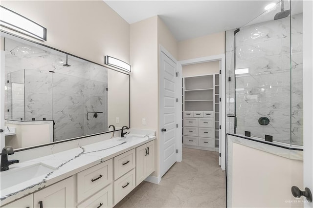 bathroom with a tile shower and vanity