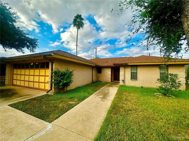 ranch-style house featuring a garage and a front lawn