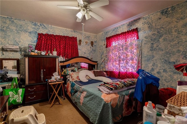 bedroom with ceiling fan and wallpapered walls