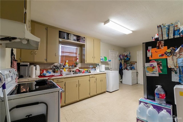 kitchen with white electric stove, washer / clothes dryer, light floors, light countertops, and under cabinet range hood