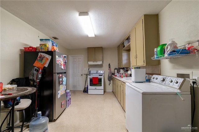 laundry room with a textured ceiling, washing machine and dryer, laundry area, visible vents, and light floors