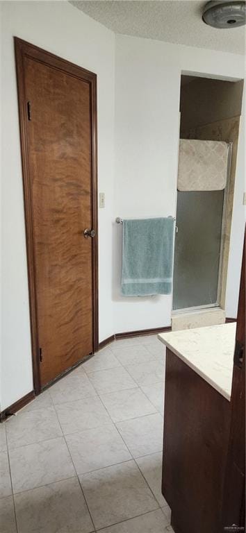 bathroom featuring baseboards and tile patterned floors