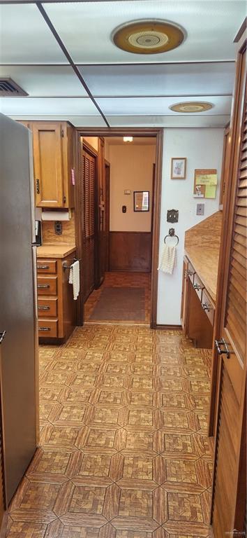hallway with tile patterned floors