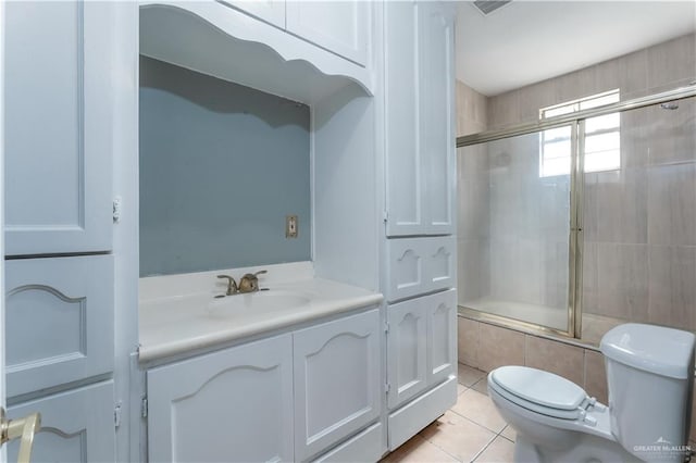 full bathroom featuring tile patterned floors, vanity, toilet, and combined bath / shower with glass door