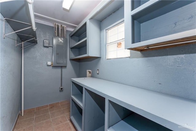 interior space featuring tile patterned flooring and electric panel