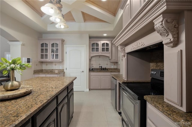 kitchen featuring light stone countertops, tasteful backsplash, appliances with stainless steel finishes, light tile patterned floors, and ornamental molding