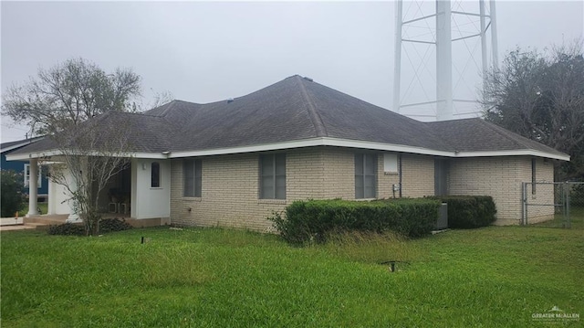 rear view of property featuring a yard