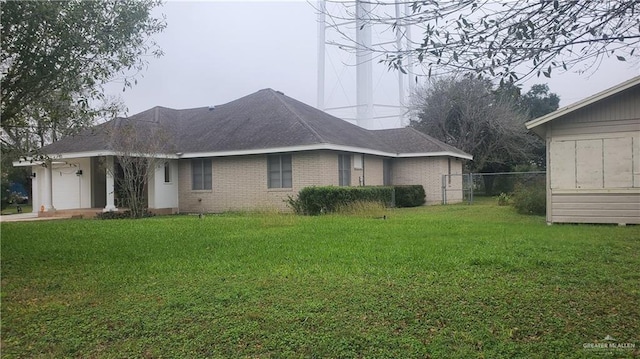 view of home's exterior with a yard and a garage