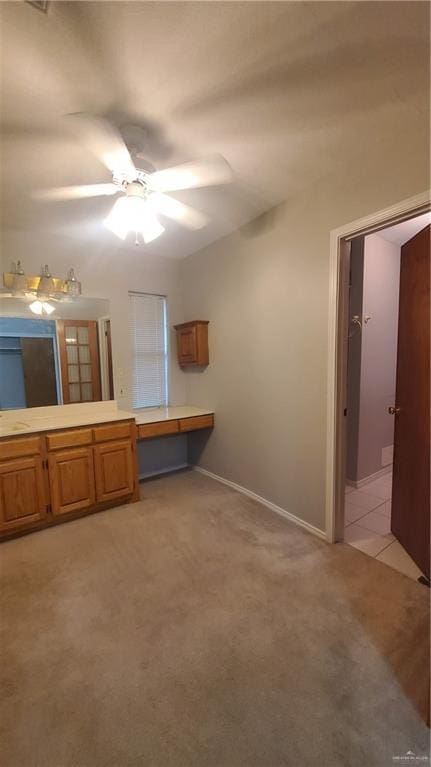 interior space featuring ceiling fan and sink