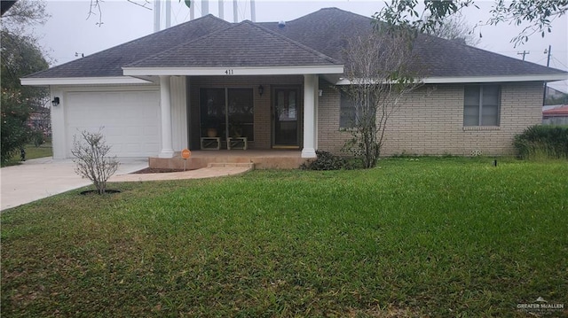 back of house with a yard, covered porch, and a garage