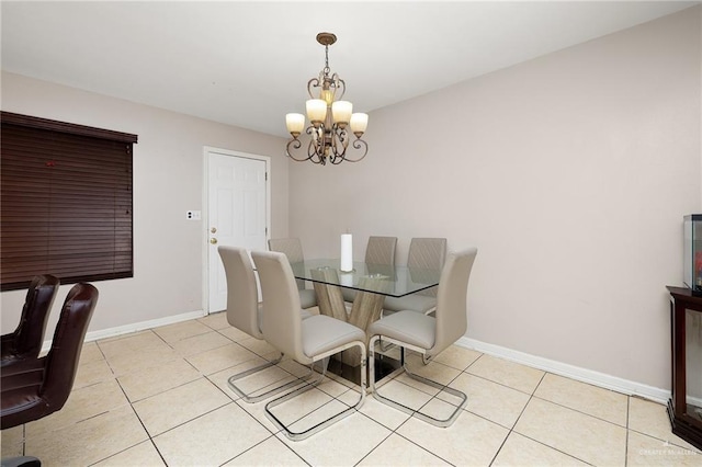 tiled dining room featuring a chandelier