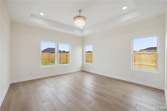 403 Faith Dr, La Feria, TX 78559 - unfurnished room featuring wood finished floors, a raised ceiling, recessed lighting, and baseboards