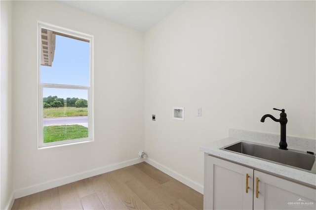 403 Faith Dr, La Feria, TX 78559 - laundry area featuring hookup for an electric dryer, a healthy amount of sunlight, cabinet space, and a sink