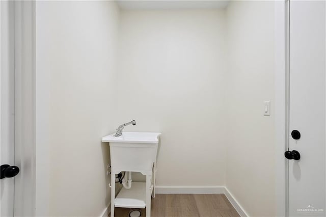 403 Faith Dr, La Feria, TX 78559 - washroom with light wood finished floors and baseboards