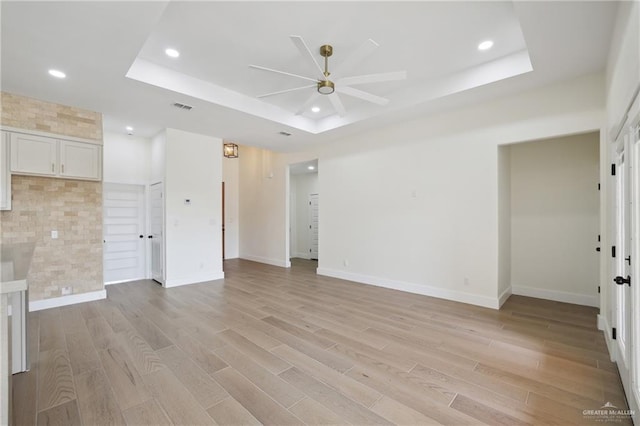 403 Faith Dr, La Feria, TX 78559 - spare room featuring light wood-style flooring, visible vents, a raised ceiling, ceiling fan, and recessed lighting