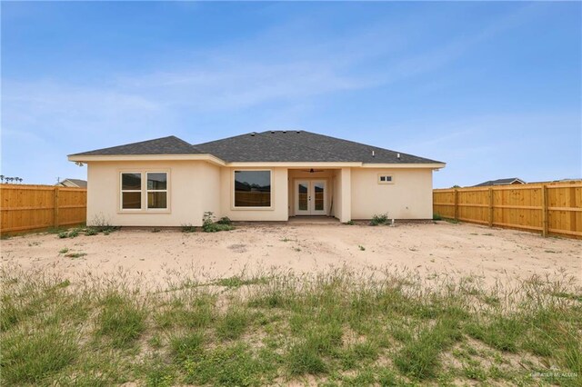 403 Faith Dr, La Feria, TX 78559 - back of property featuring french doors, a fenced backyard, and stucco siding