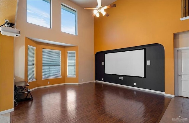 1915 Bunting Ln, Mission, TX 78572 - cinema room featuring wood finished floors, a ceiling fan, and a high ceiling