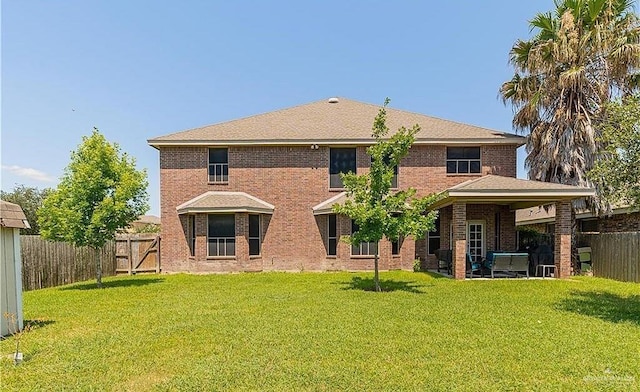 1915 Bunting Ln, Mission, TX 78572 - back of house with a fenced backyard, brick siding, and a gate