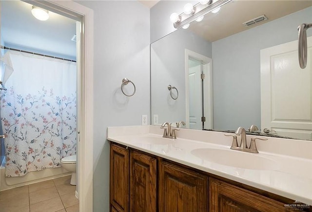 1915 Bunting Ln, Mission, TX 78572 - full bath with double vanity, tile patterned floors, and shower / bath combo with shower curtain