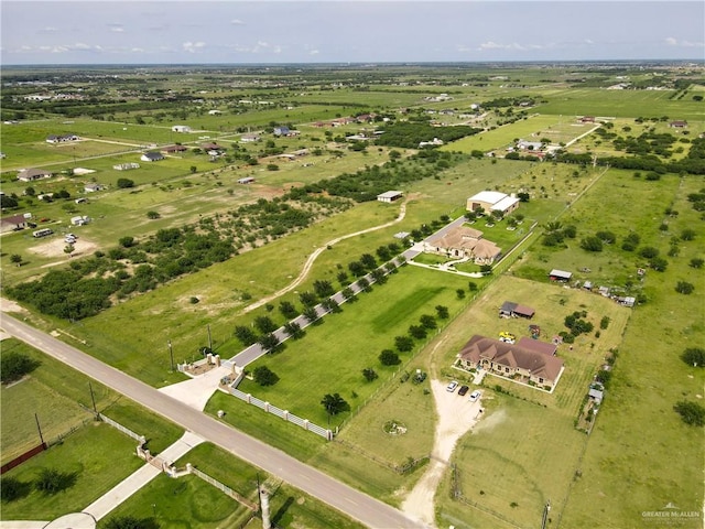 birds eye view of property with a rural view