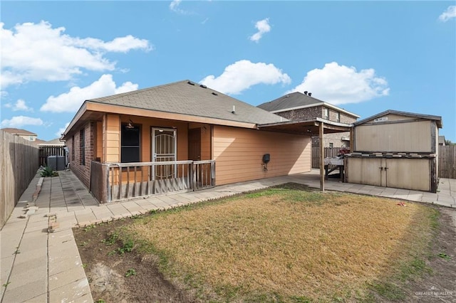 back of property featuring a patio and a lawn