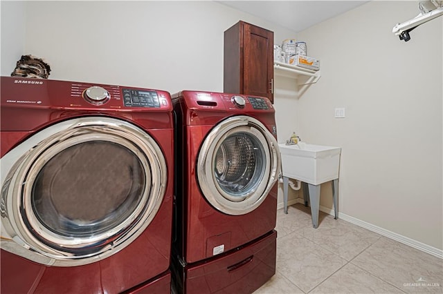 laundry area featuring independent washer and dryer and light tile patterned floors