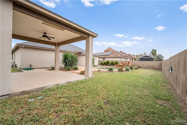 view of yard with ceiling fan and a patio area