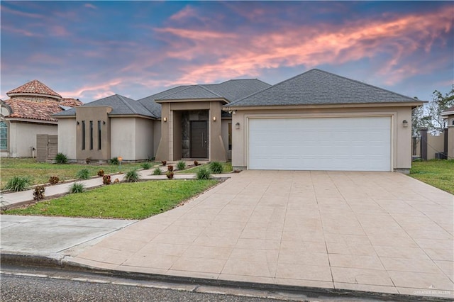 view of front of home featuring a garage and a yard