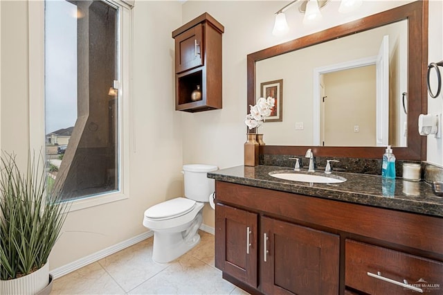 bathroom with vanity, tile patterned flooring, plenty of natural light, and toilet