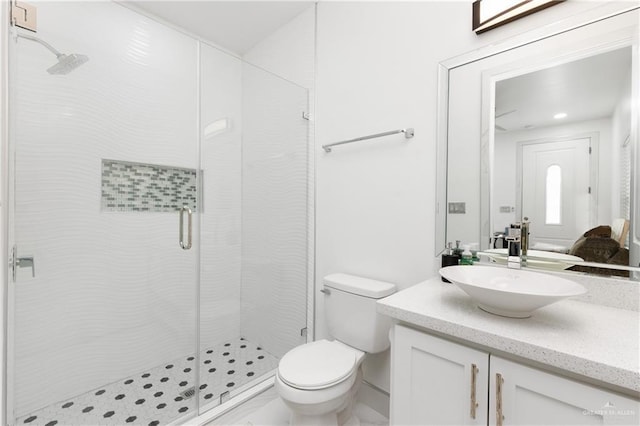 bathroom with vanity, toilet, and walk in shower