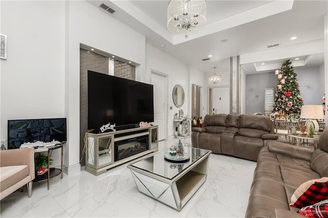 living room featuring a chandelier and a tray ceiling