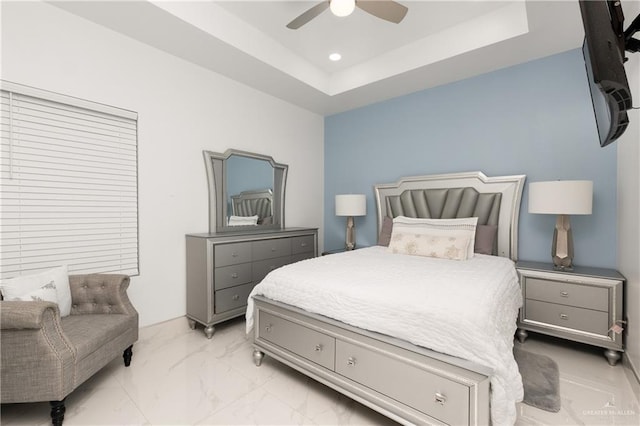 bedroom featuring a tray ceiling and ceiling fan