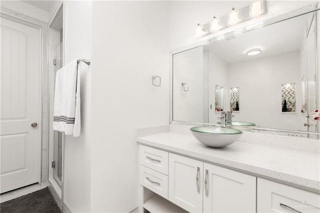 bathroom featuring vanity, tile patterned floors, and walk in shower