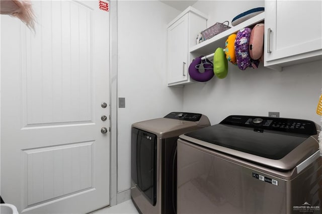 laundry area featuring cabinets and washing machine and dryer