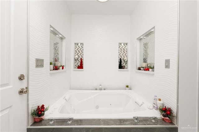 bathroom featuring tiled tub