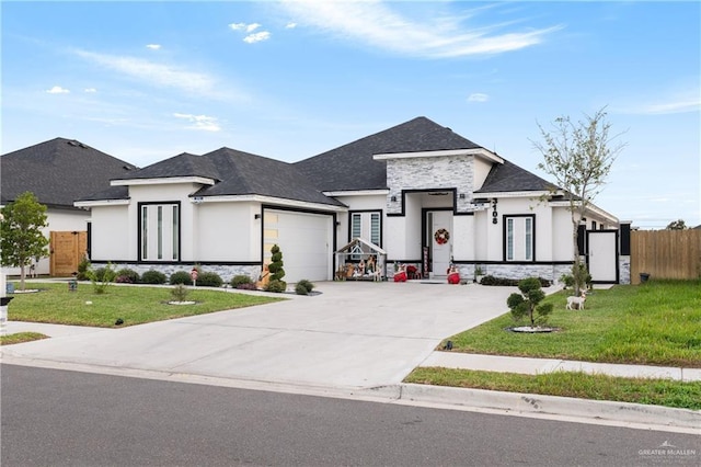 view of front of home with a garage and a front lawn