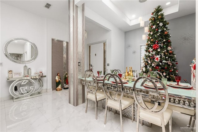 dining space with a tray ceiling