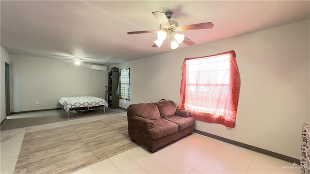 bedroom with ceiling fan and an AC wall unit