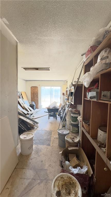 miscellaneous room with a textured ceiling