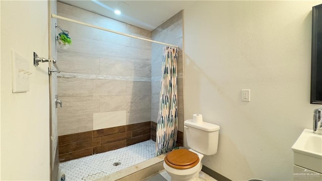 bathroom with walk in shower, vanity, and toilet