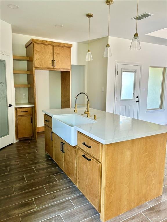 1804 Hailey St, San Juan, TX 78589 - kitchen with visible vents, a kitchen island with sink, a sink, decorative light fixtures, and wood tiled floor