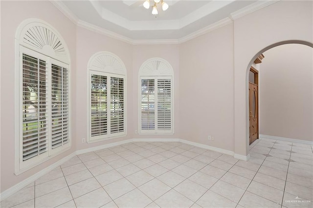 2206 Kings Dr, Edinburg, TX 78539 - spare room featuring light tile patterned floors, arched walkways, a tray ceiling, ceiling fan, and ornamental molding