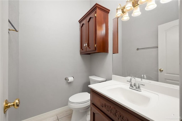 2206 Kings Dr, Edinburg, TX 78539 - bathroom with toilet, vanity, tile patterned floors, baseboards, and a chandelier