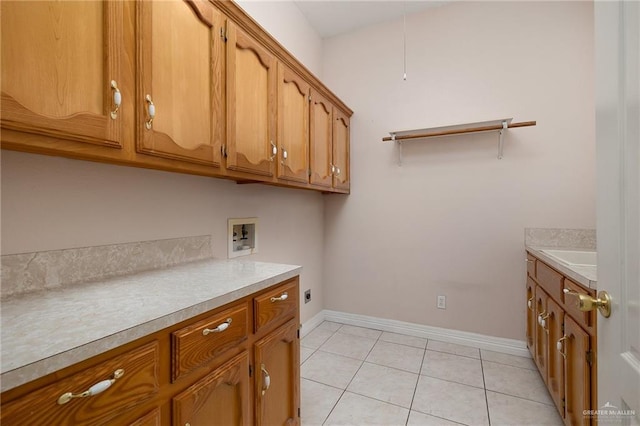 washroom with hookup for a washing machine, light tile patterned flooring, cabinets, and hookup for an electric dryer