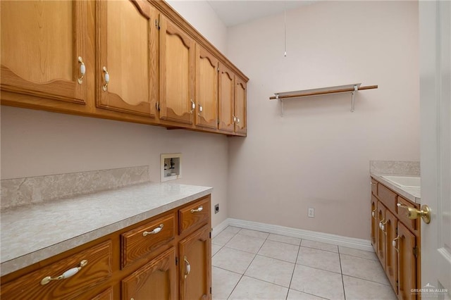2206 Kings Dr, Edinburg, TX 78539 - laundry room with cabinet space, washer hookup, electric dryer hookup, baseboards, and light tile patterned floors