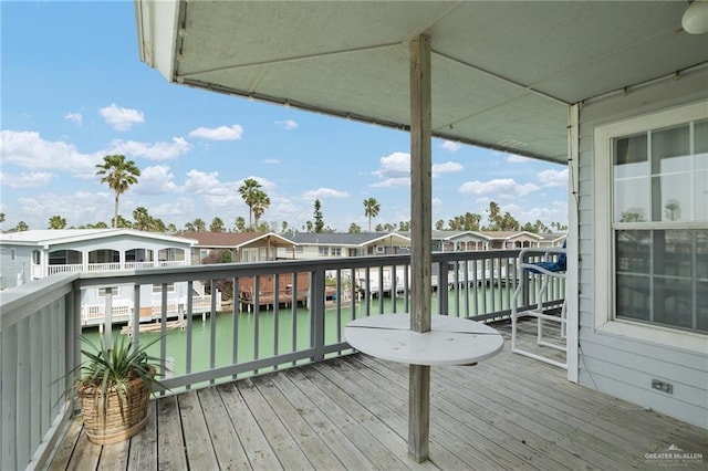 wooden deck with a water view and a residential view